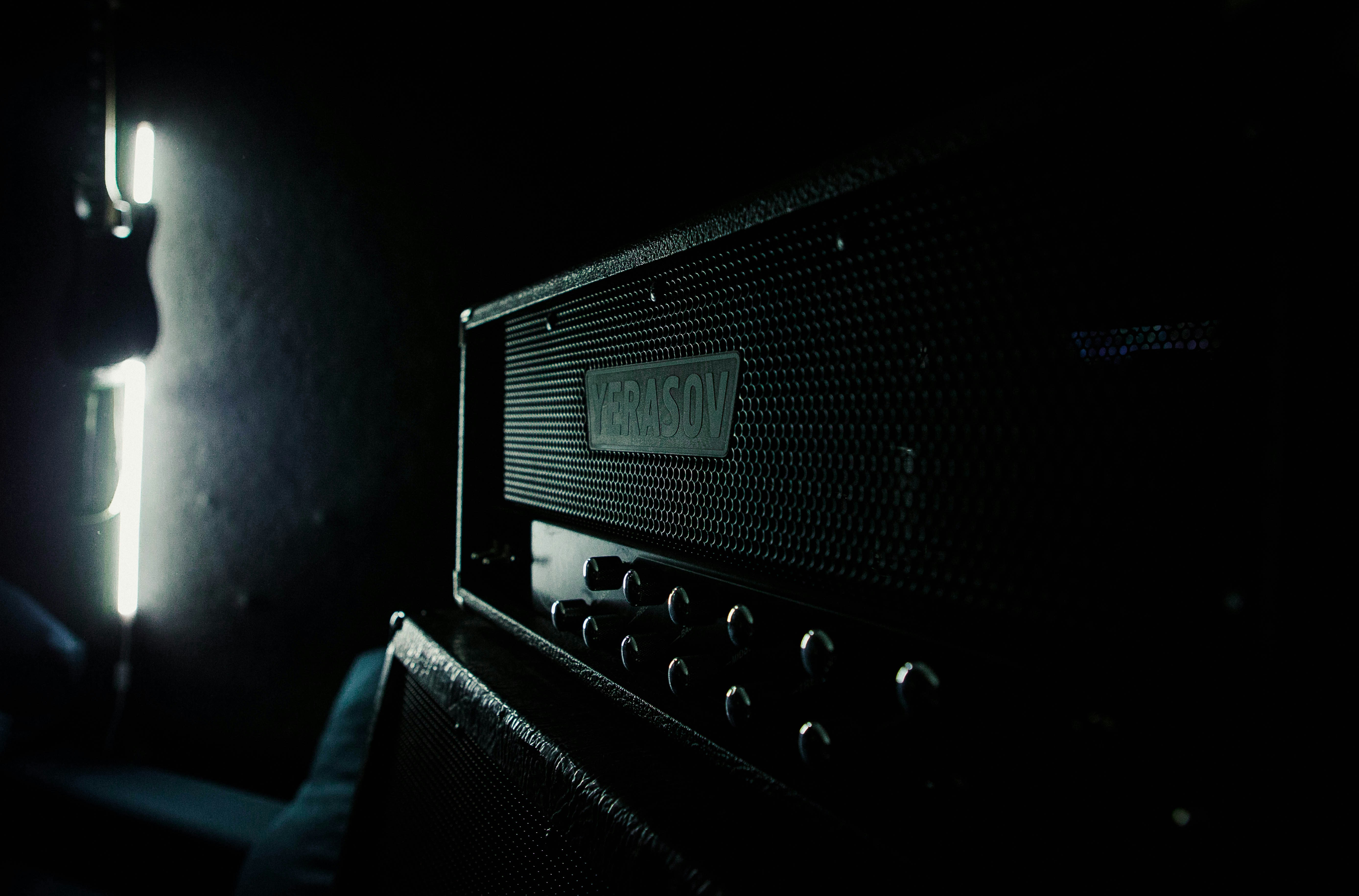 Amplifier head with control knobs in a dimly lit setting.
