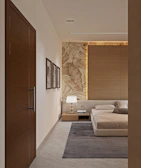 Contemporary bedroom with a bed, nightstand, lamp, and textured wall.