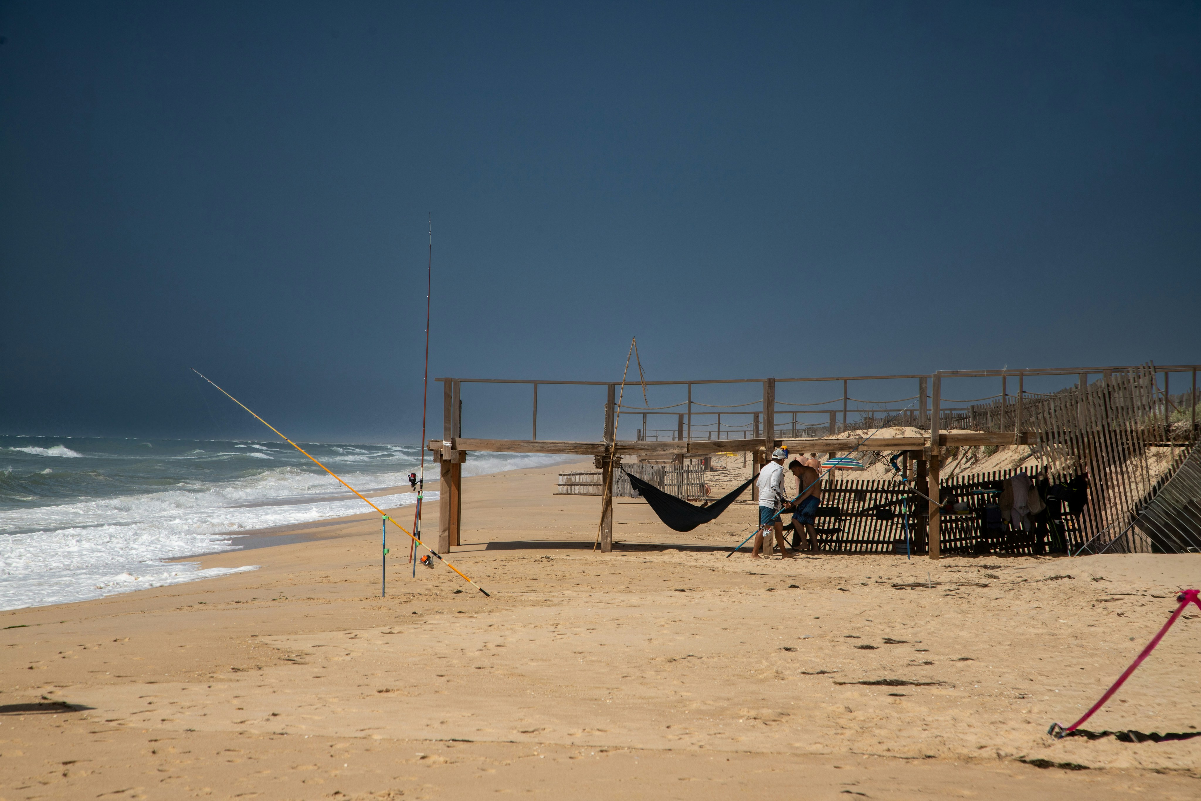 People relaxing on a sandy beach with ocean waves.