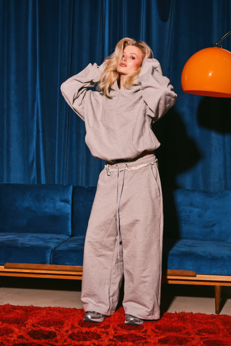 Grey hoodie and pants against a blue background