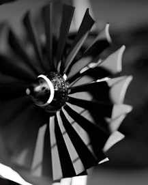 Black and white view of a spinning jet engine turbine.