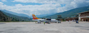 A plane parked at a mountain airport