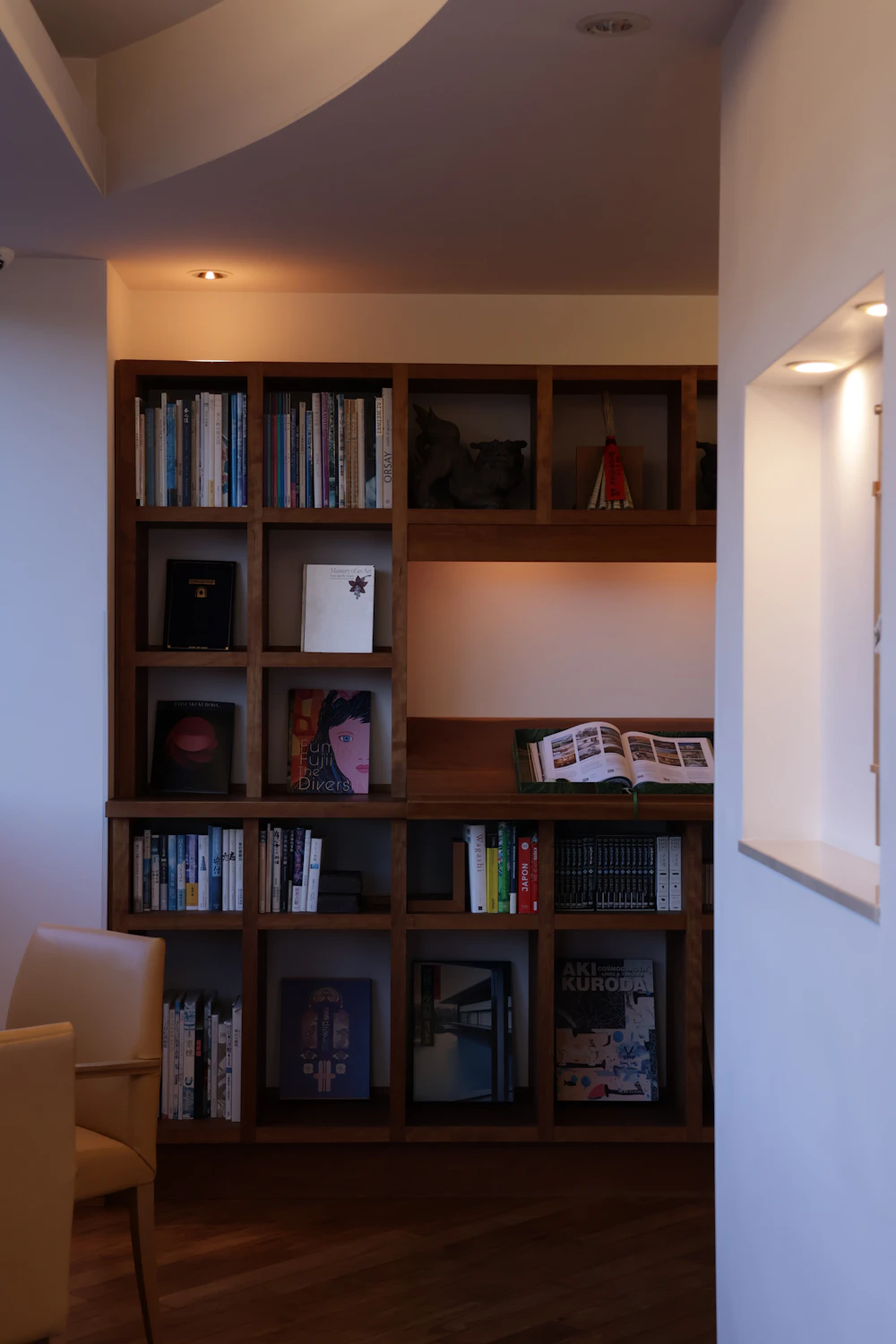 Quiet wood-paneled reading alcove with warm ambient light