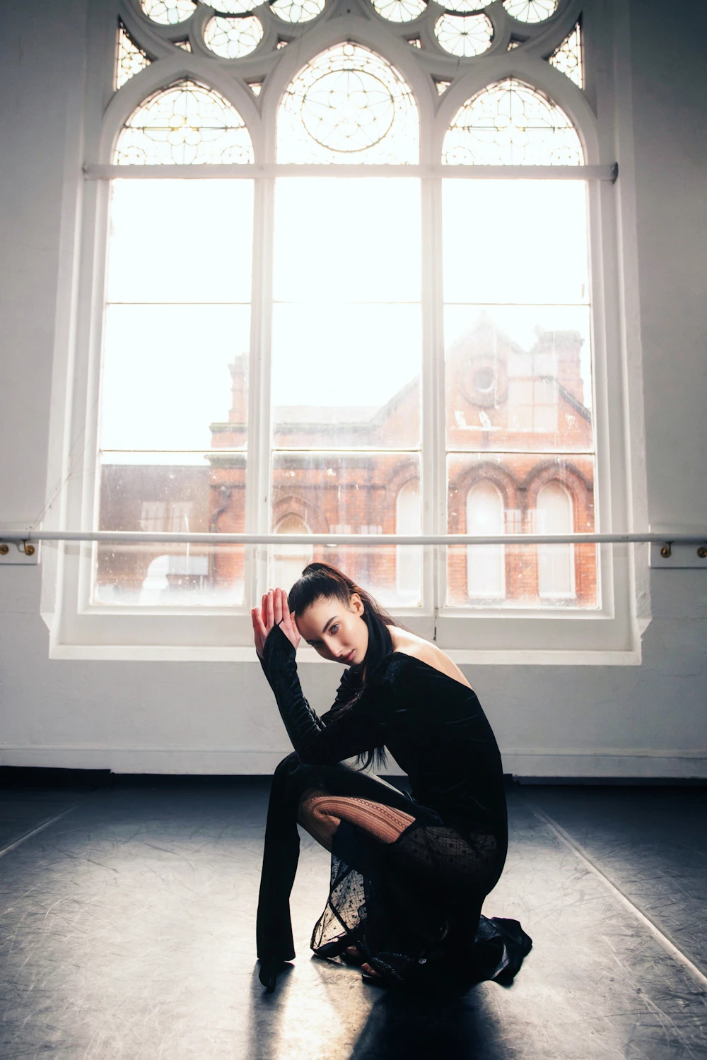 Dancer posing in a bright dance studio
