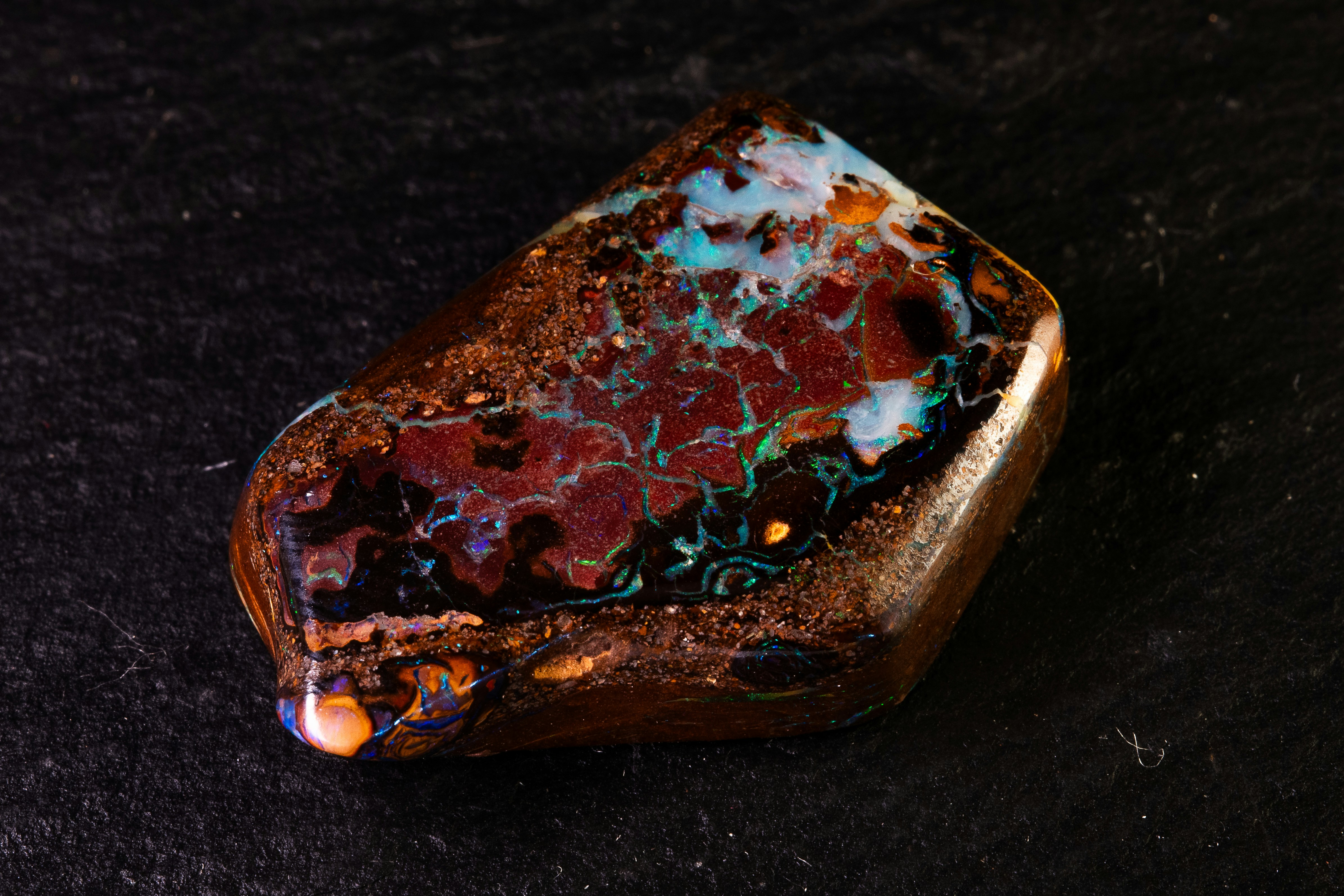 A beautiful dark opal gemstone with vibrant colors.