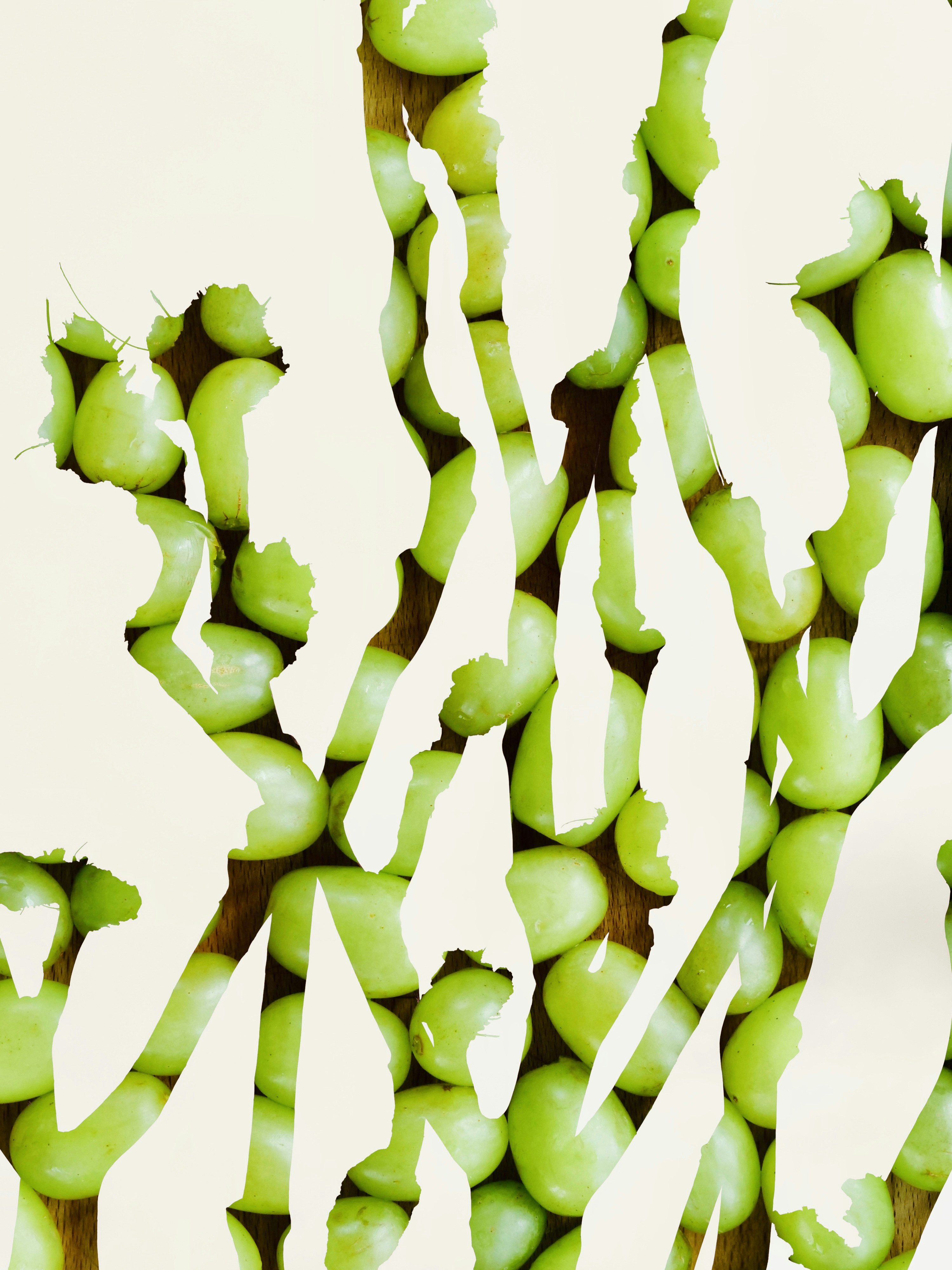 A double exposure of a crepe myrtle tree and green grapes