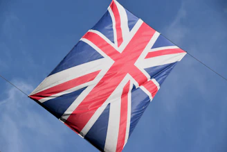 A union jack flag flying against a clear blue sky
