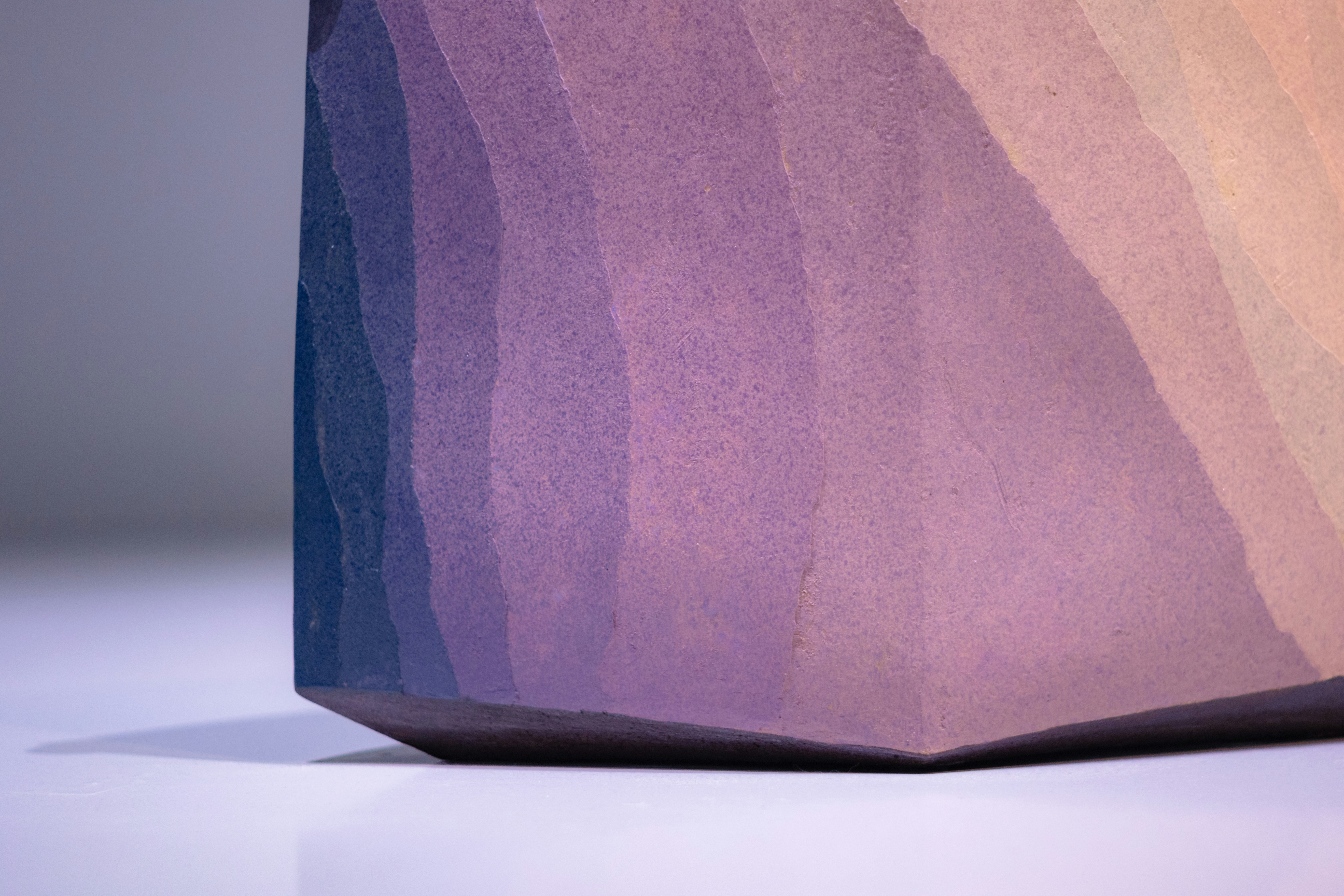 Textured object with a colorful gradient from blue to orange.