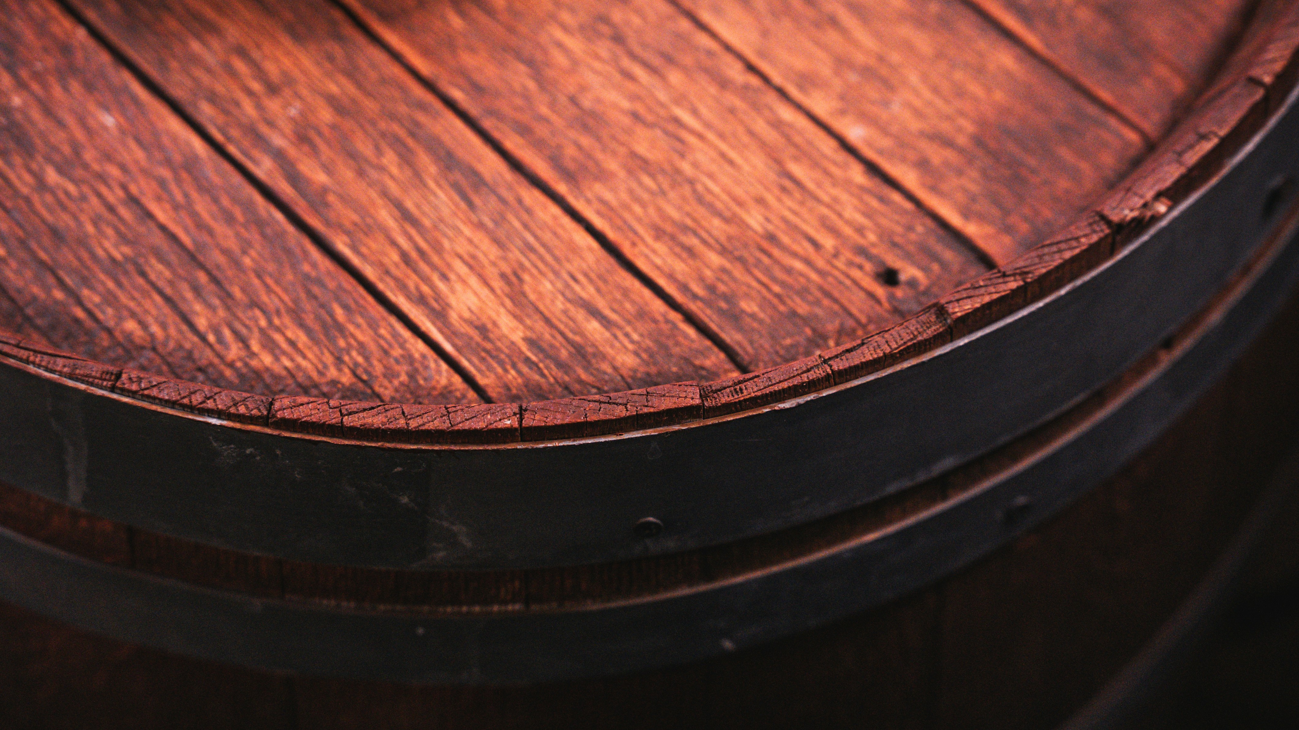 Rustic wooden barrel with dark metal bands.