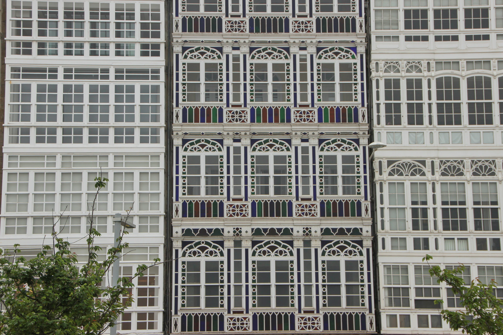 Ornate white balconies and windows on a building facade