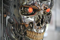 Chrome robotic skull with glowing red eyes.