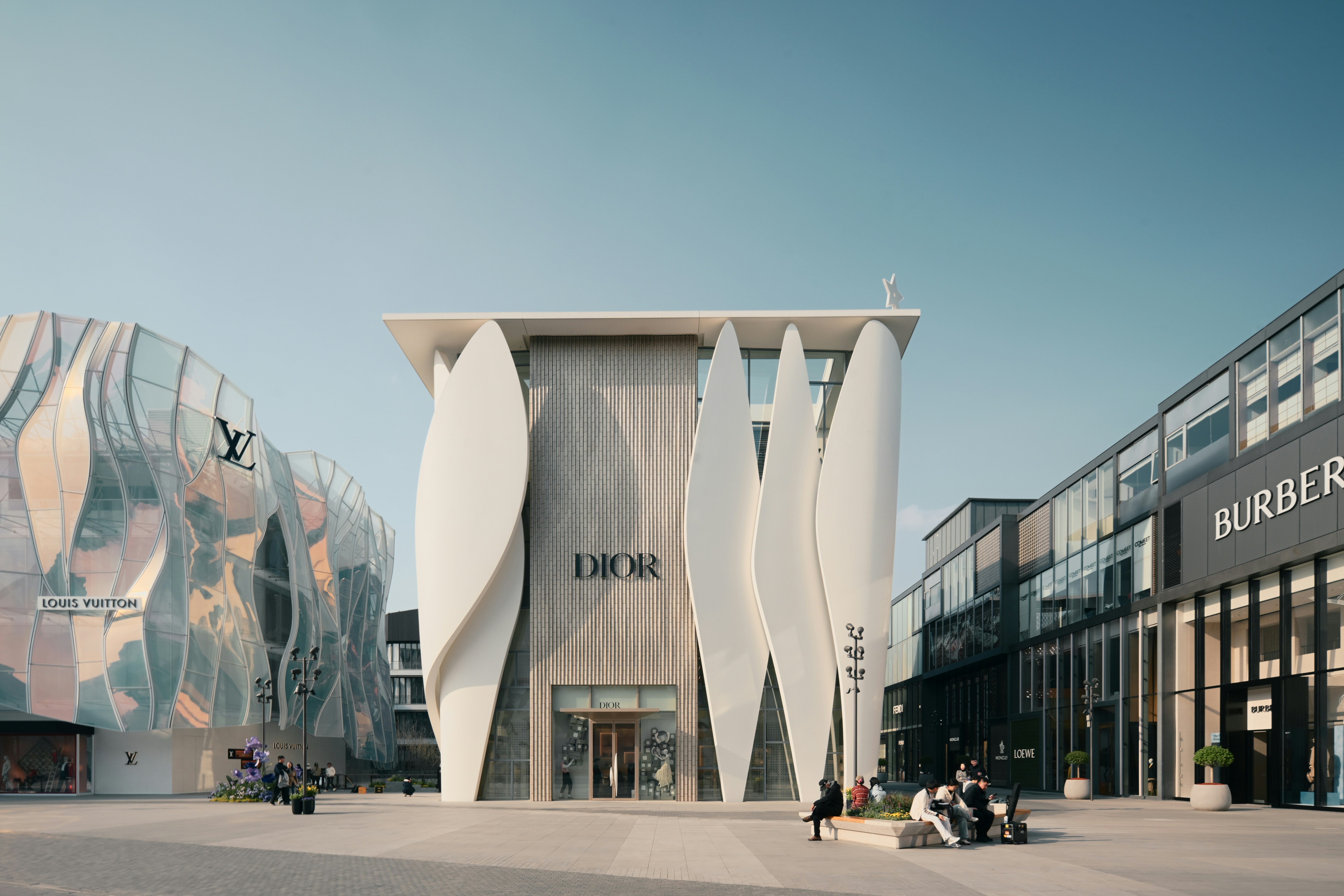 A modern dior store building surrounded by luxury brands.