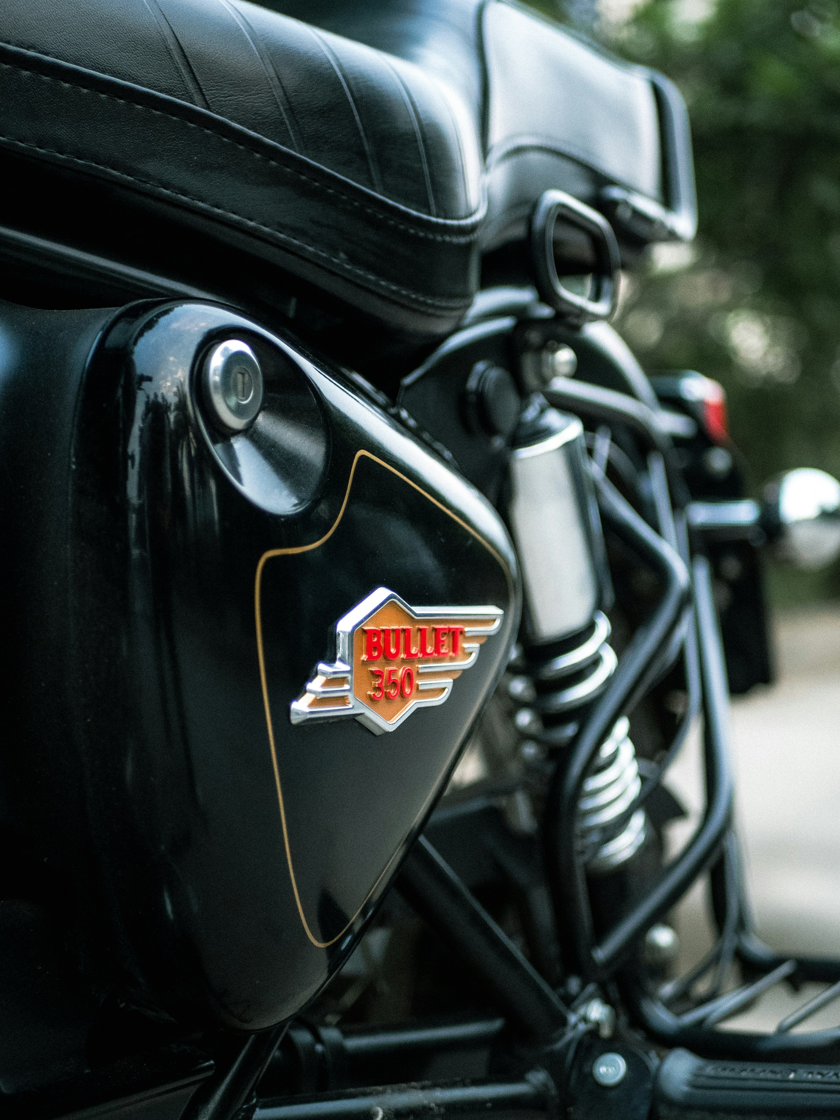 Black motorcycle's side panel featuring a "bullet 350" emblem.