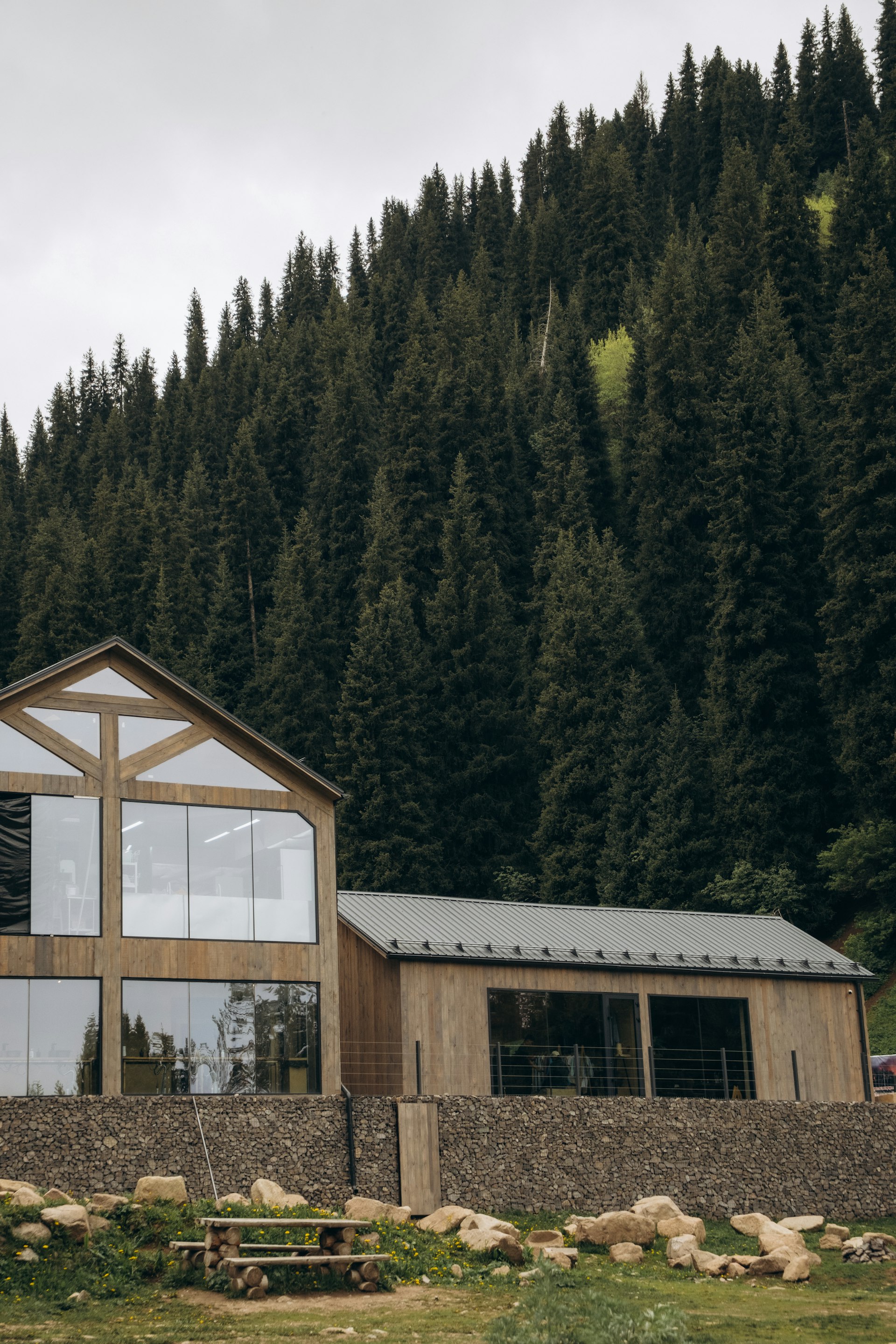 Timber-and-glass Alder & Stone home against a Wasatch pine ridge