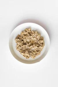 A bowl of oatmeal on a white background.