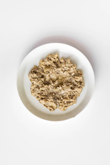A bowl of oatmeal on a white background.