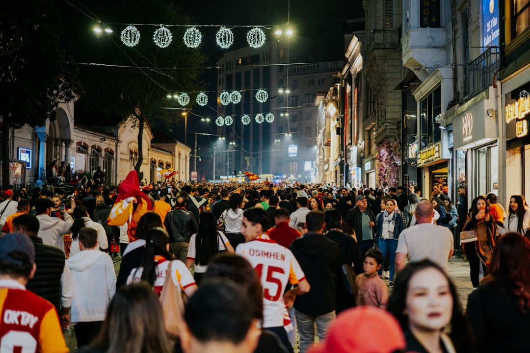 Crowds of people on a bustling city street at night.