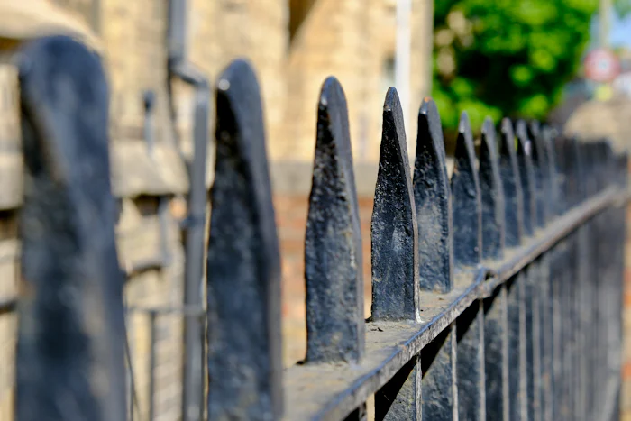 Row of pointed black wrought iron fence pickets