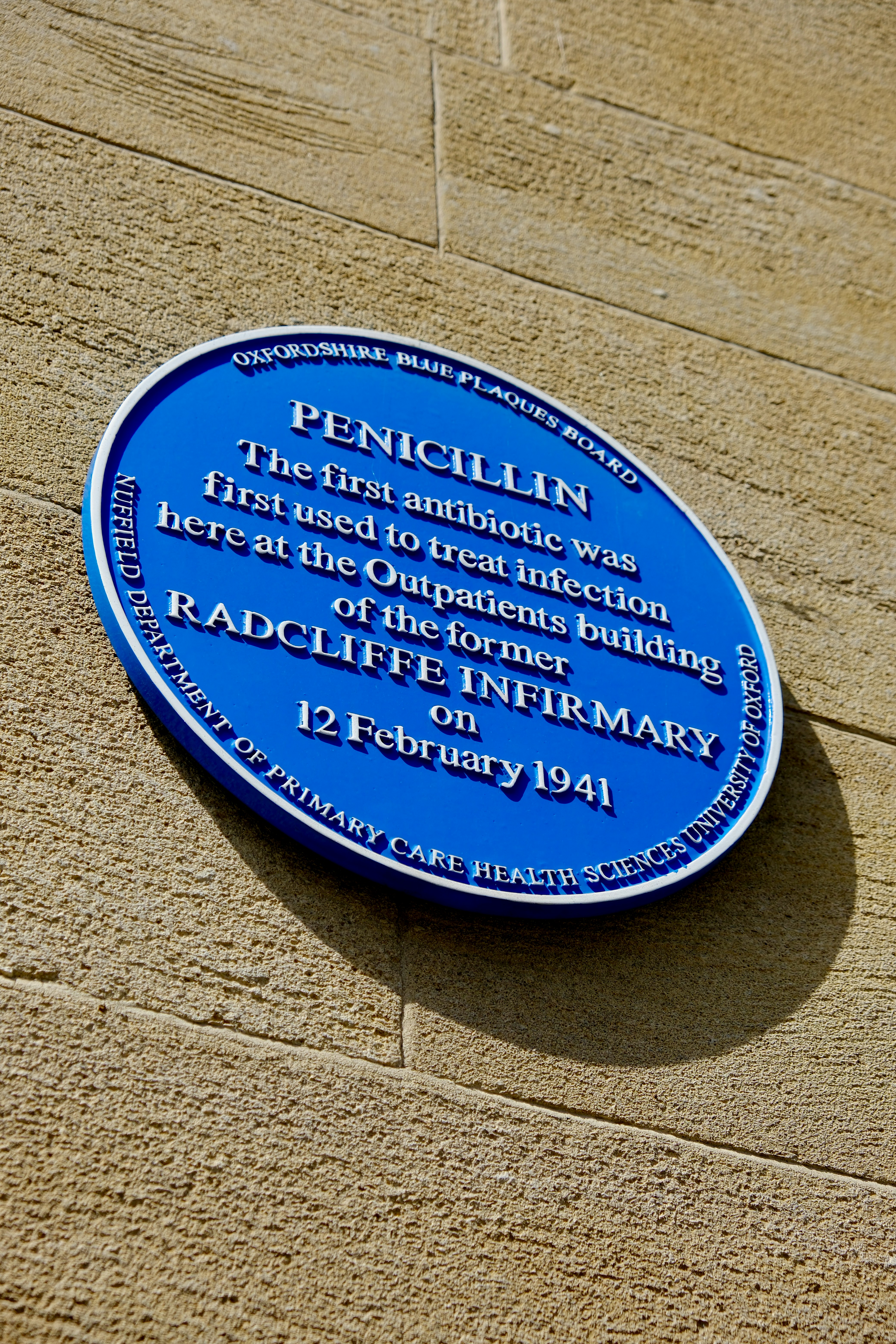 A blue plaque commemorating penicillin on a stone wall.