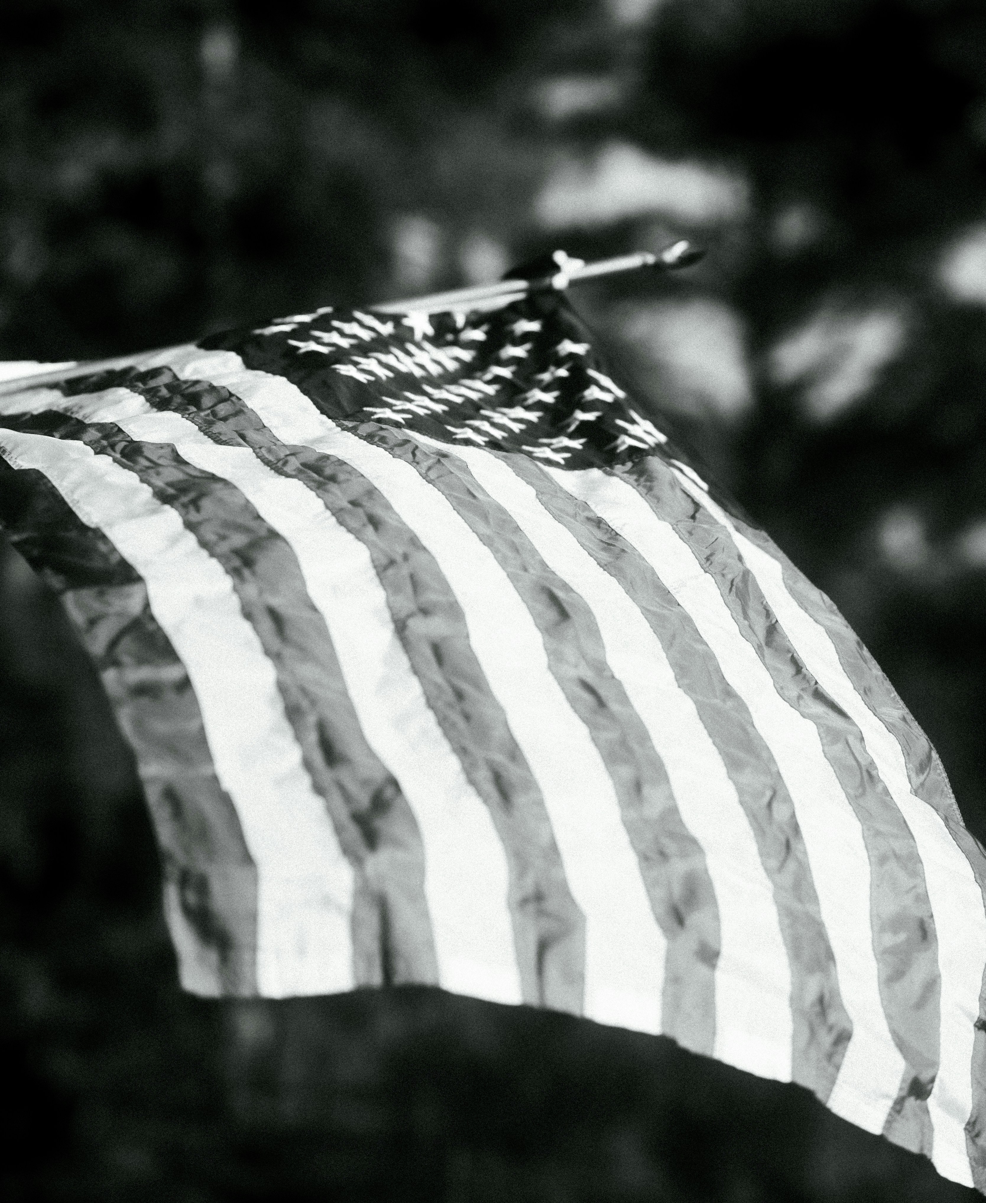 A black and white american flag waving.