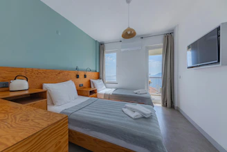 Twin beds in a bright room with a sea view.