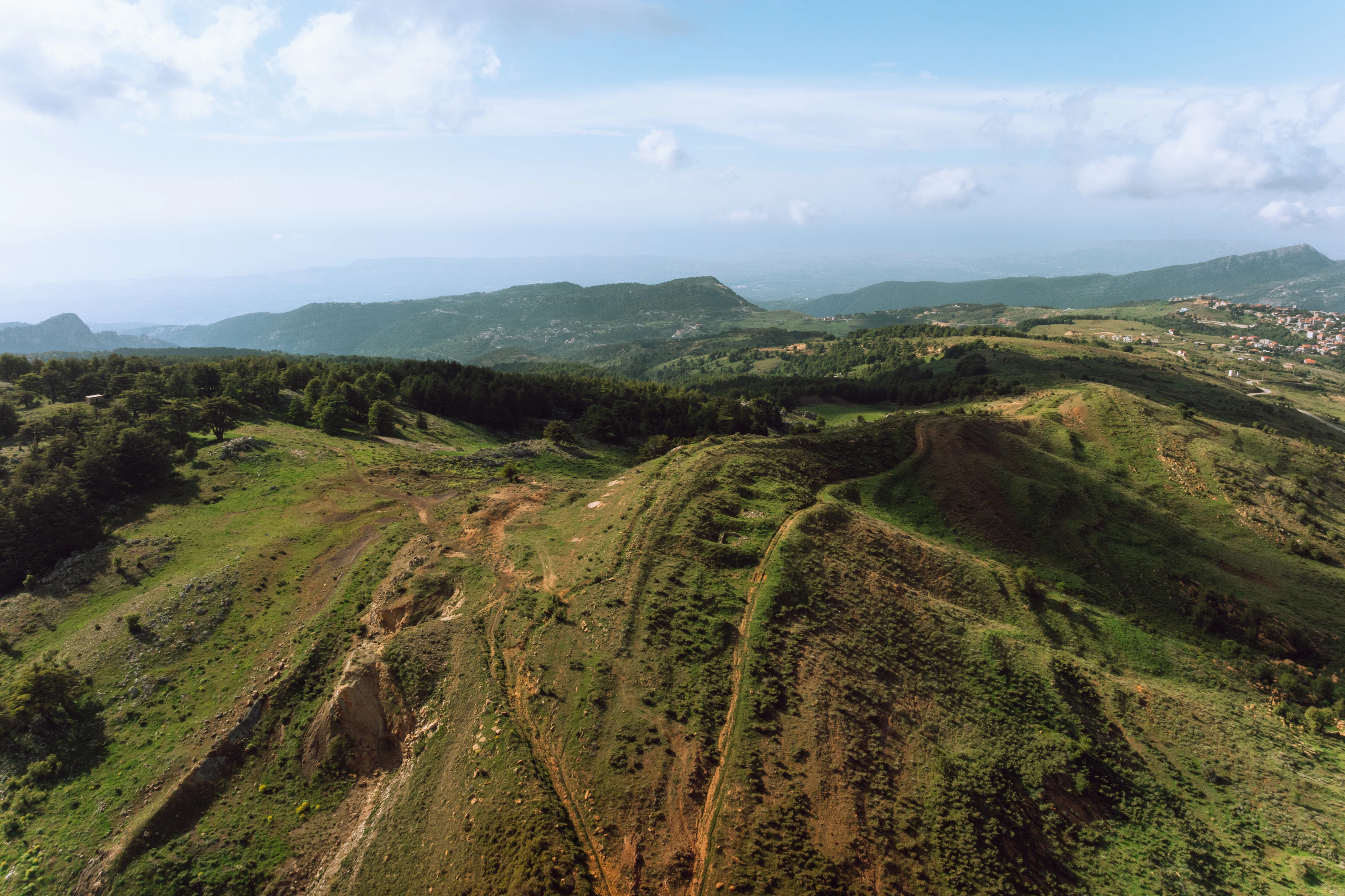 Green hills rolling towards distant mountains