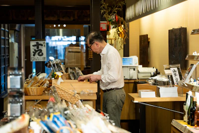 Man organizing items in a traditional shop.