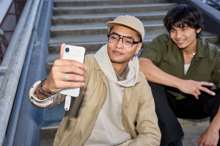 Two young men taking a selfie on stairs