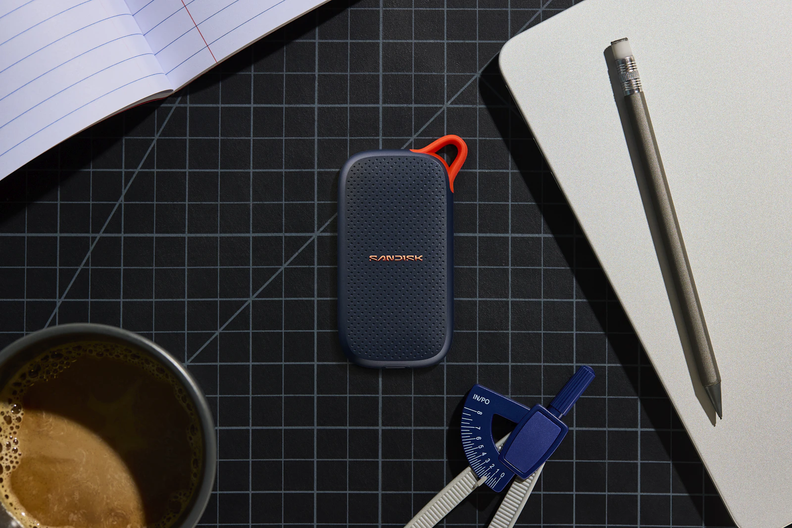 Portable solid state drive arranged with stationery on a desk