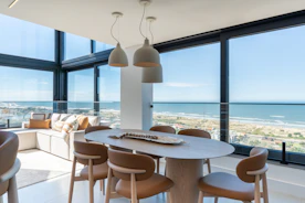 Contemporary dining area overlooking the beach and ocean.