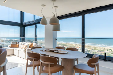 Contemporary dining area overlooking the beach and ocean.