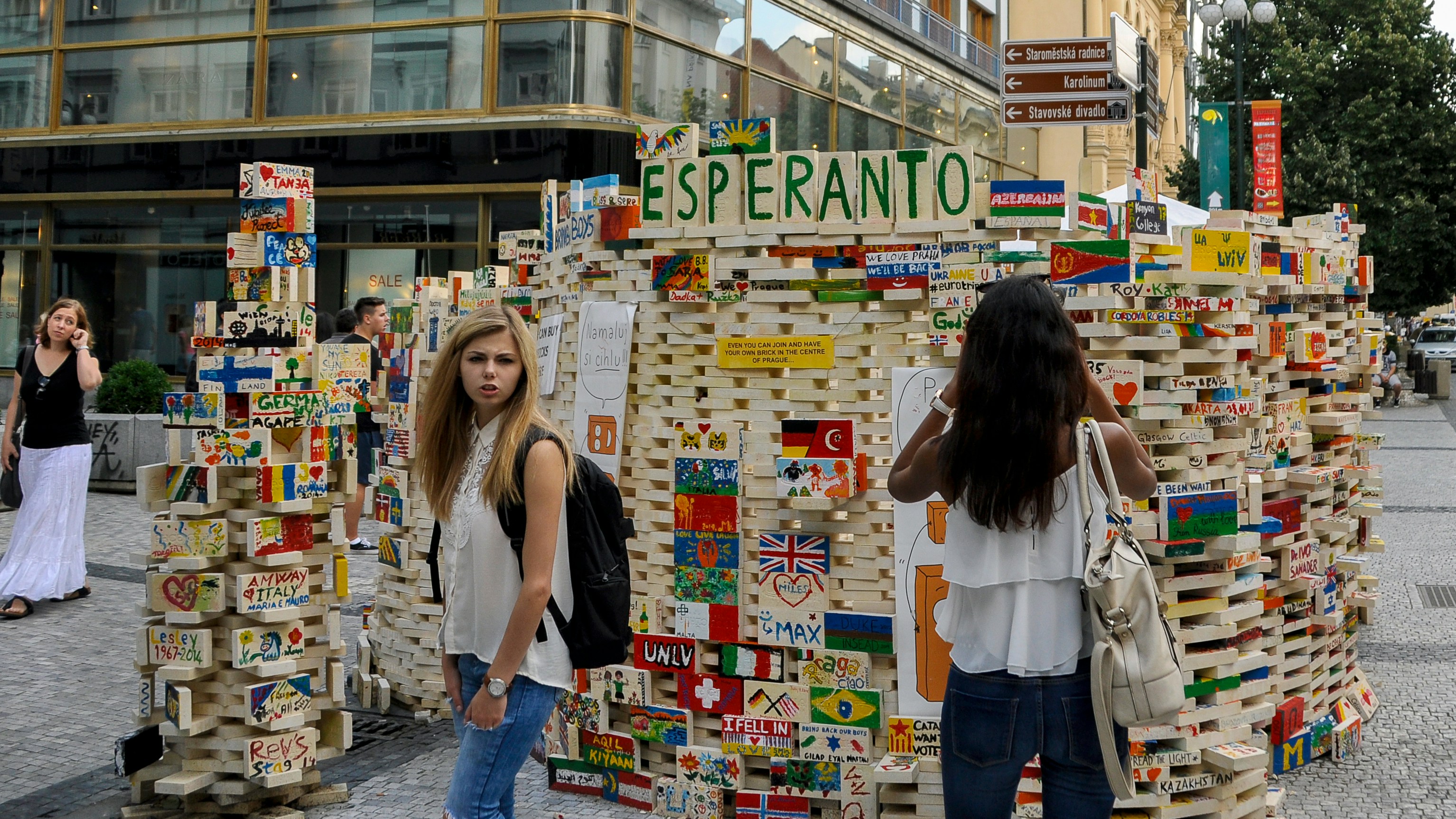 Two young women standing near a structure labeled "esperanto".