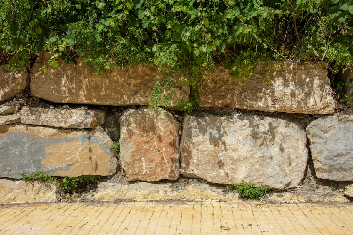 A wall of large stacked limestone blocks