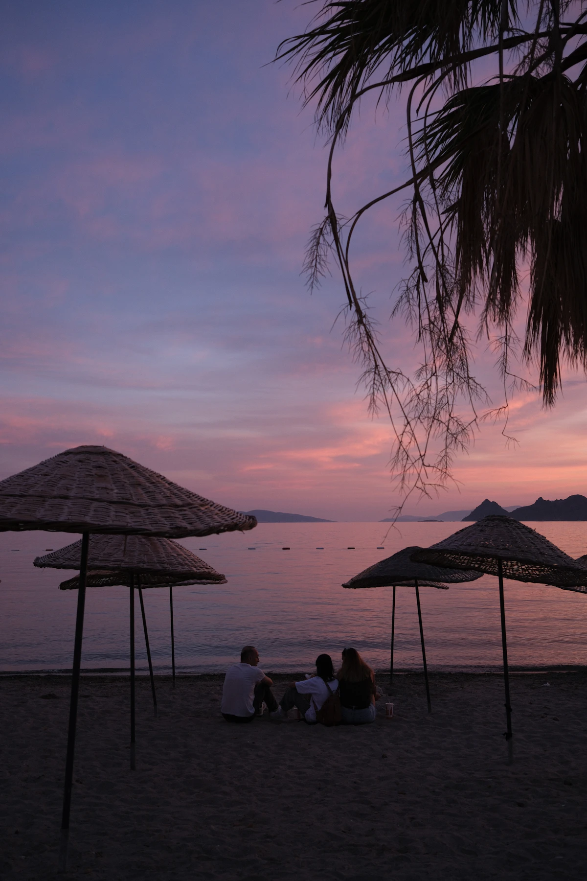 Beach umbrellas at sunset in Gumbet, Bodrum