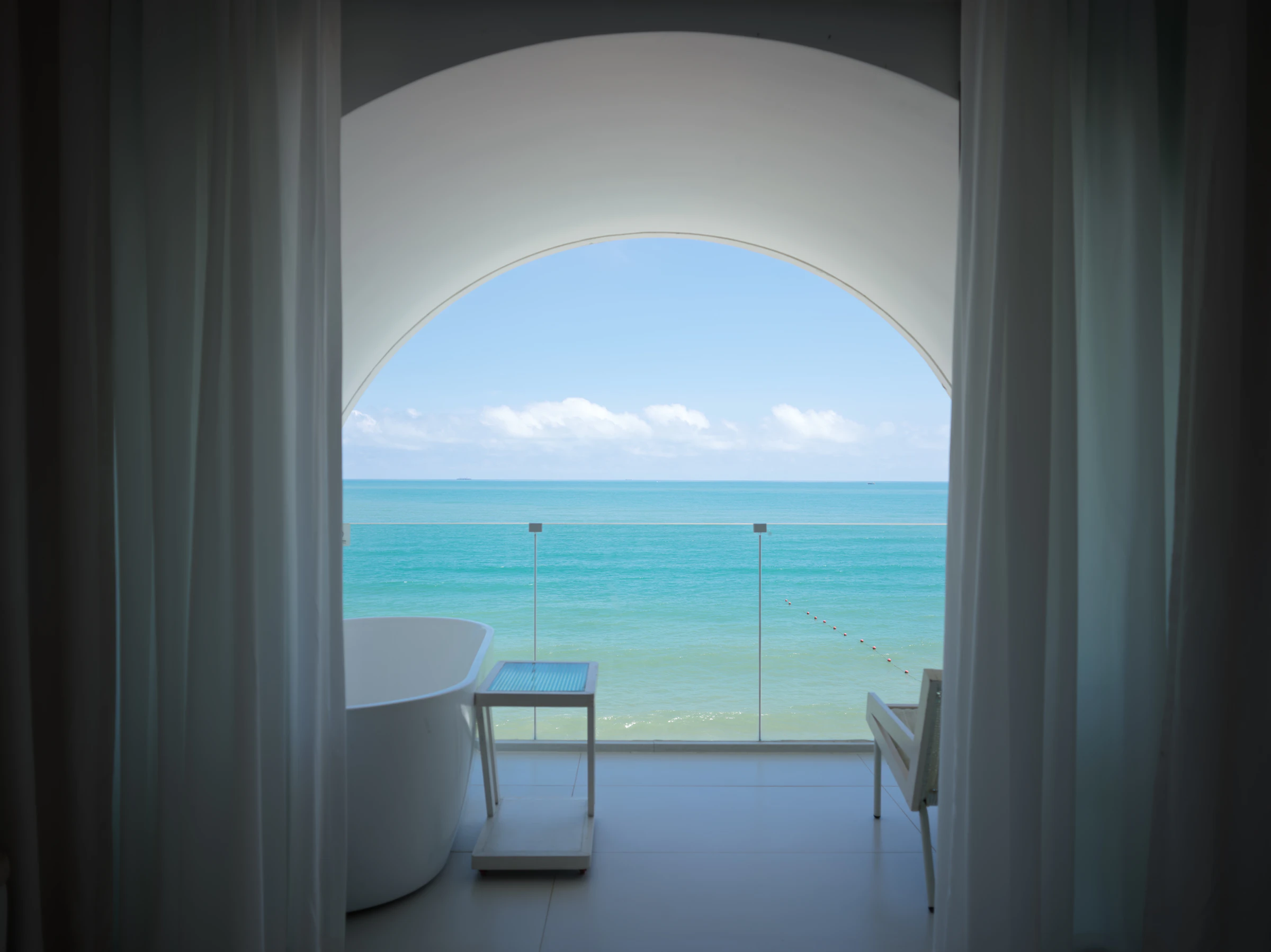 A calm sea view through an arched window