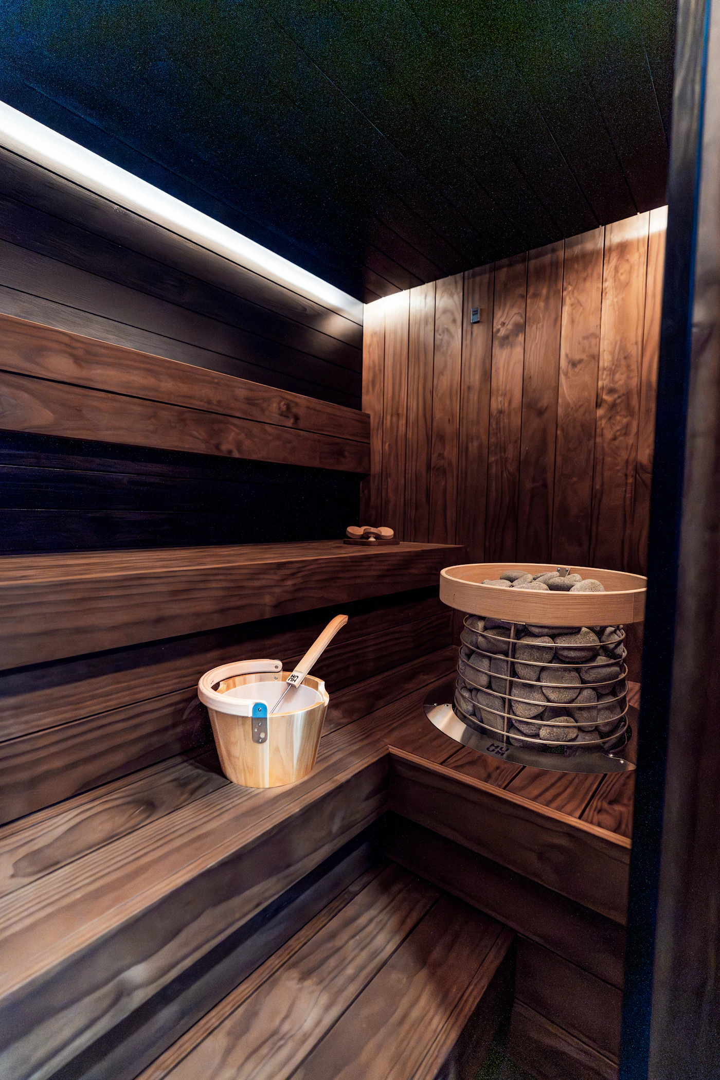 Dark modern sauna interior with warm lighting
