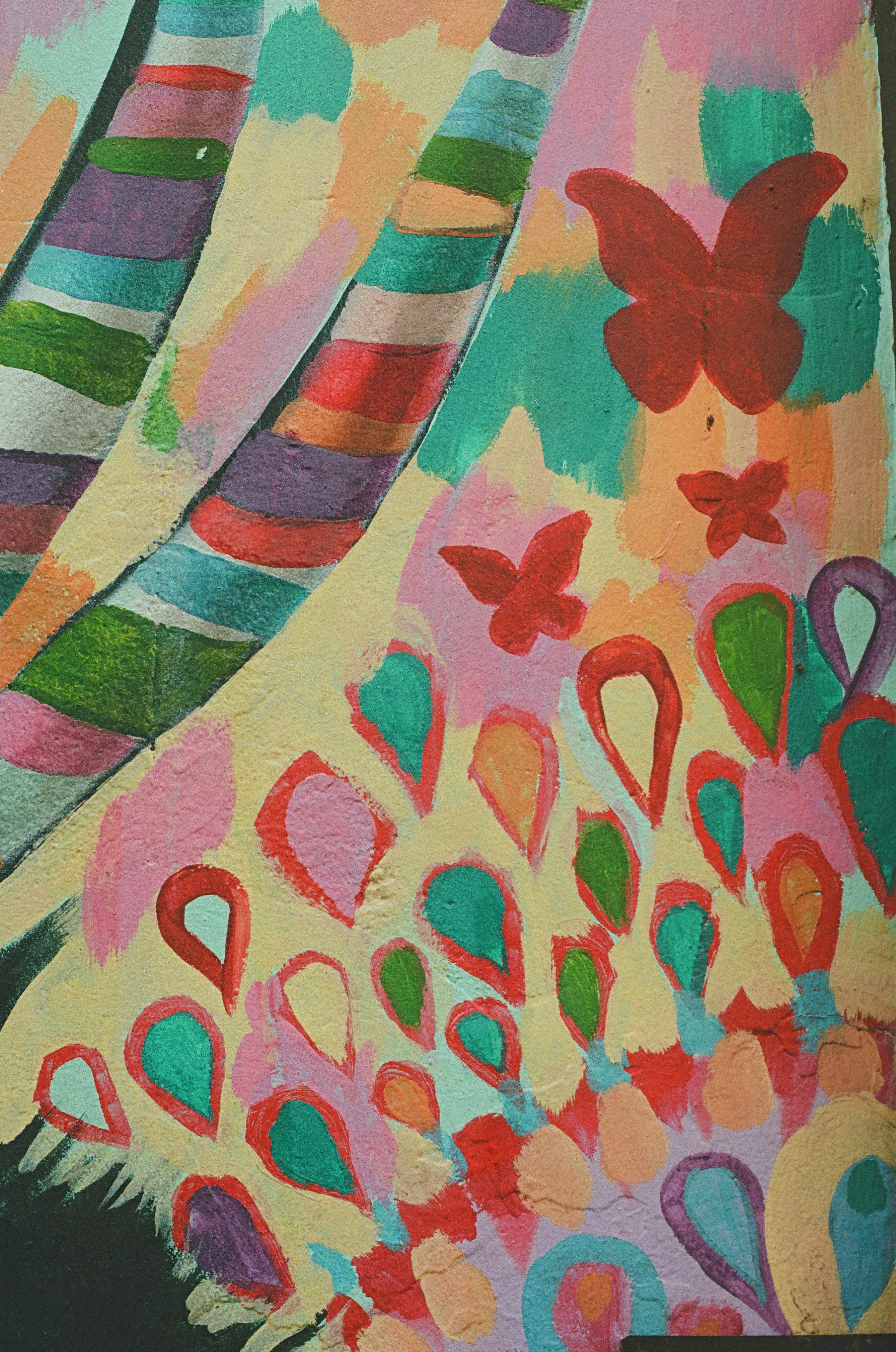 Vibrant abstract painting featuring butterflies, stripes, and colorful patterns.