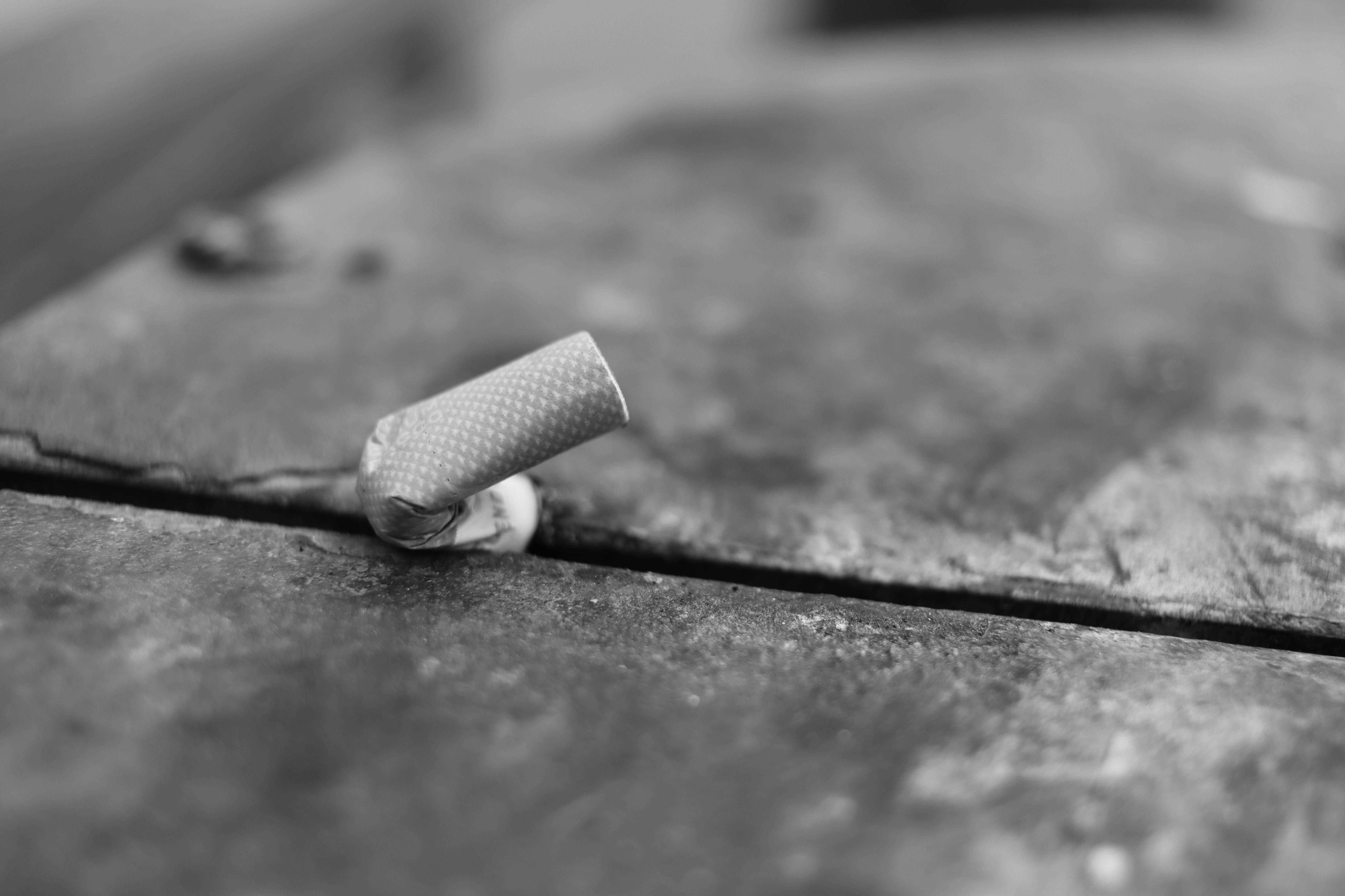 Textured cylindrical object on a rustic surface.