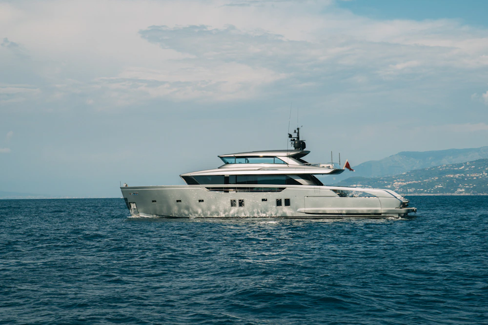 Luxury yacht cruising through clear blue Mediterranean water