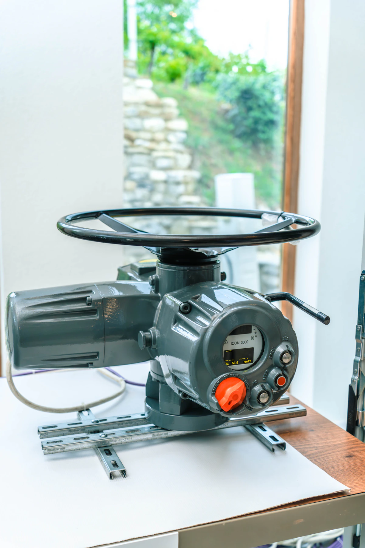 An industrial valve wheel mounted on a pipe, analogous to choosing a learning step size by feel, where turning too far risks a burst pipe and turning too little changes nothing
