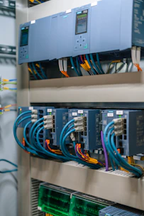 Industrial control panel with electronic modules and colorful wiring.