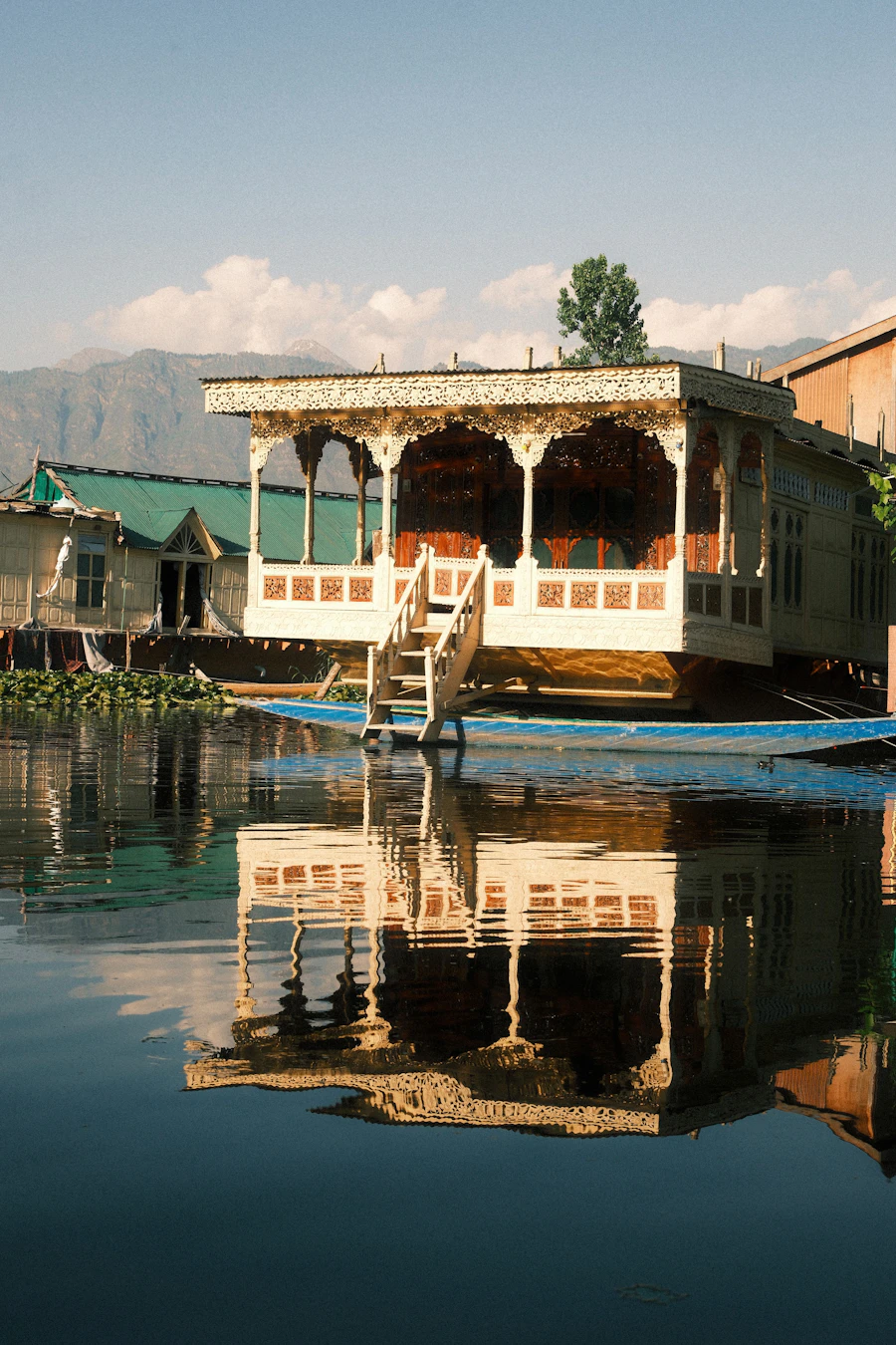 Traditional houseboat reflected on Dal Lake, Srinagar