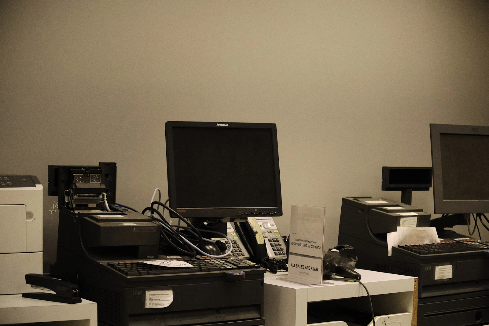 Row of checkout registers and monitors at a retail counter where automated workflows run on every transaction