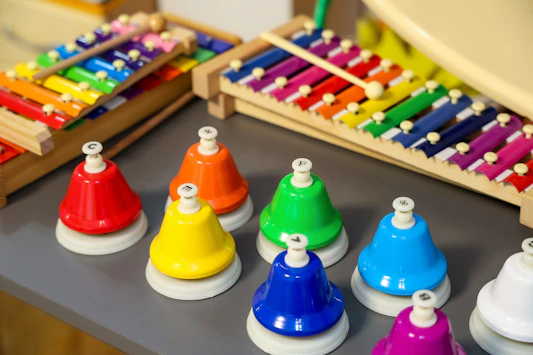 A collection of colorful handbells and xylophones