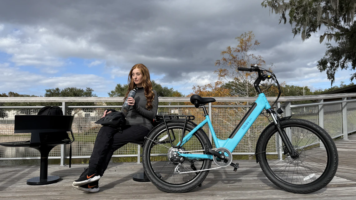 Urban rider beside an electric bicycle in an outdoor city setting