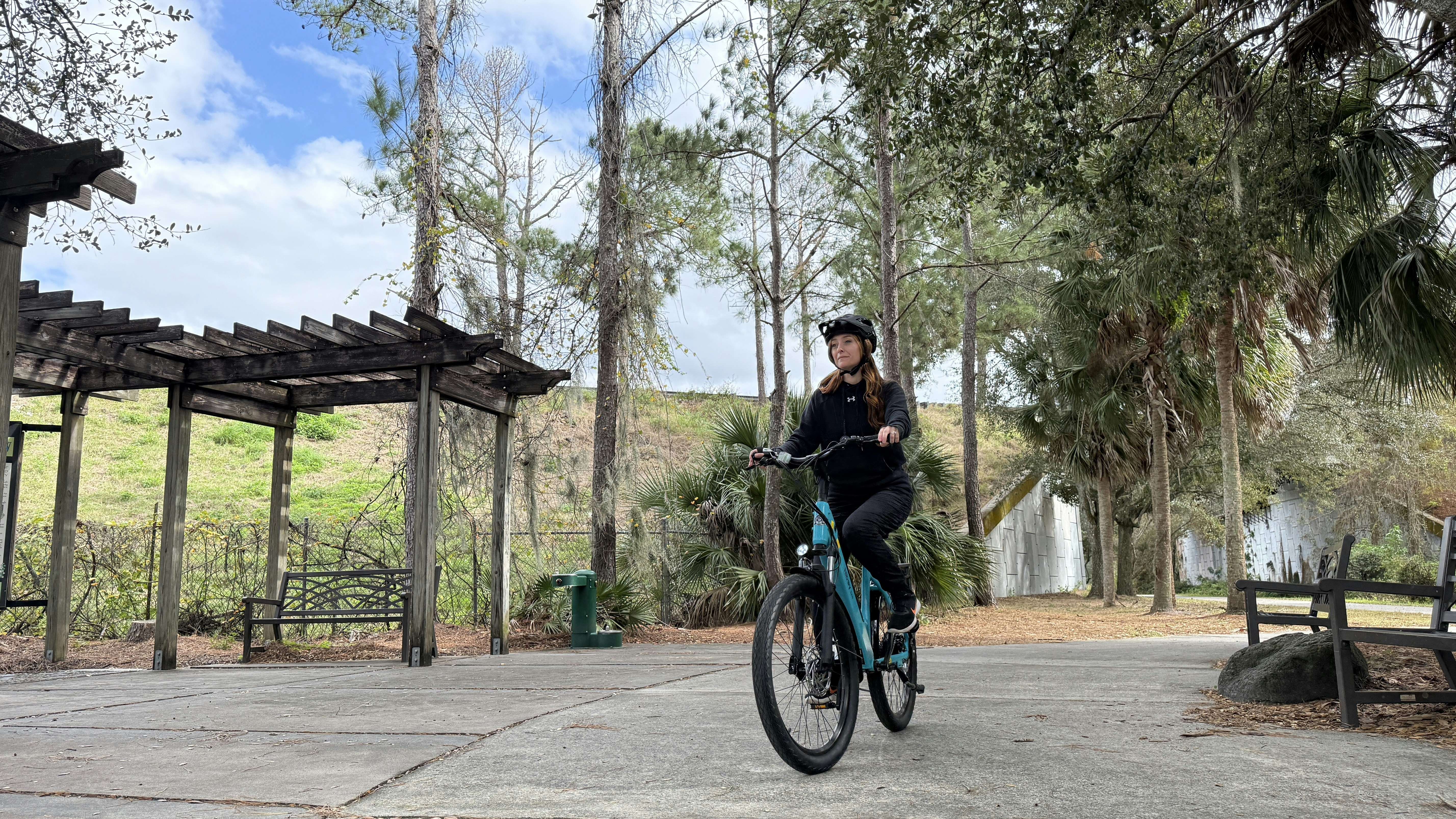 Woman riding a bicycle on a park path