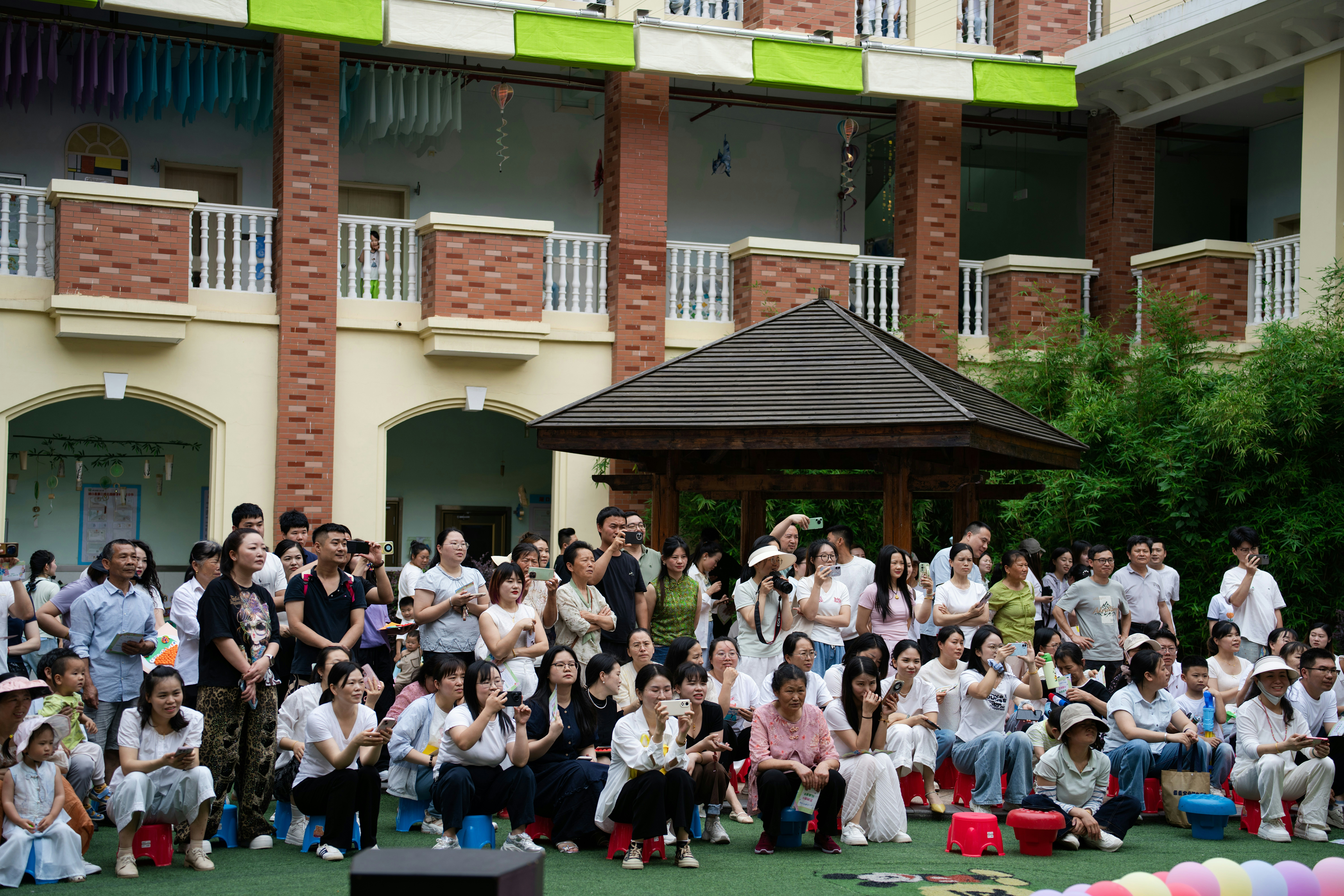 Large group of people watching an outdoor performance.