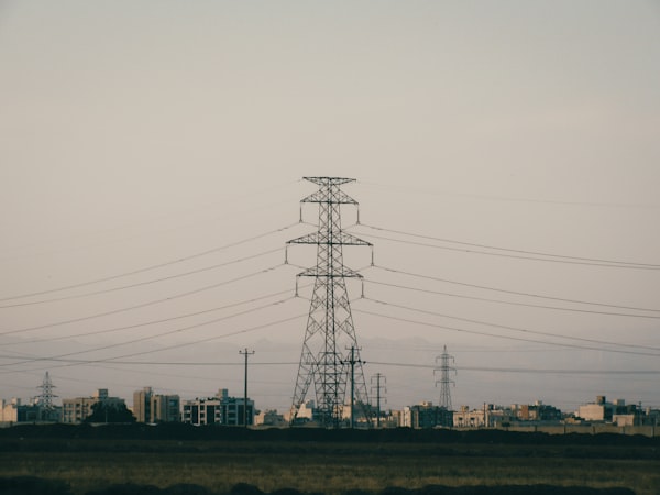 Power lines crossing above a distant city