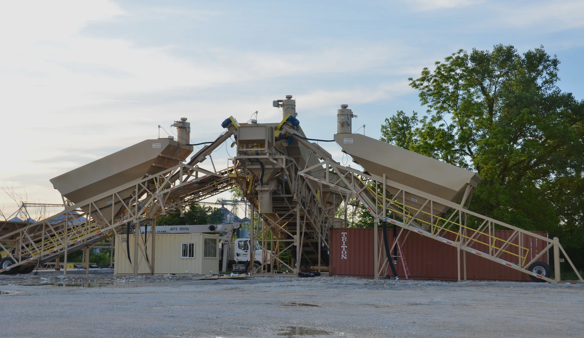 A collapsed industrial concrete plant structure under a cloudy sky.