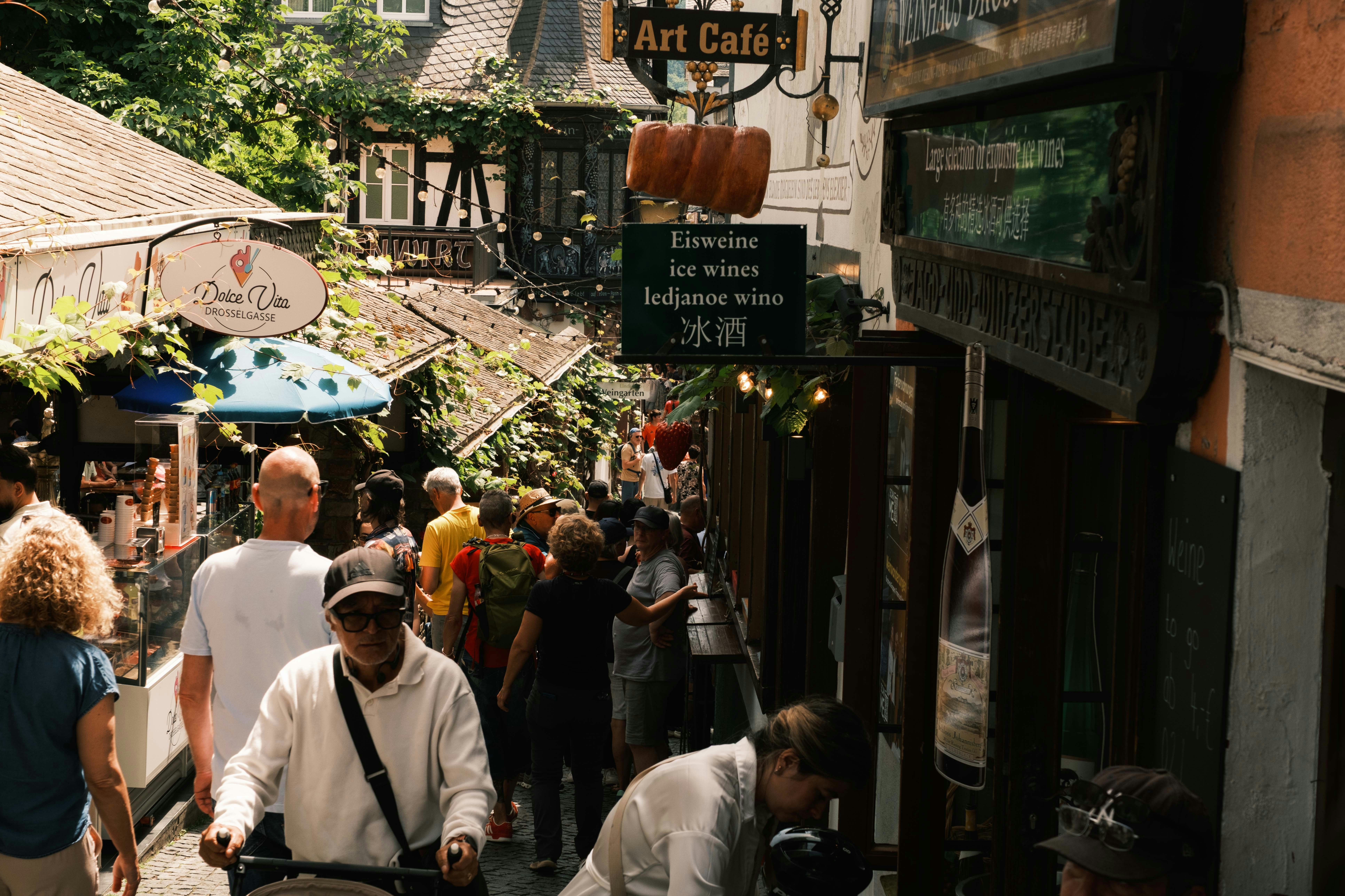 Travellers walking through a narrow historic city street